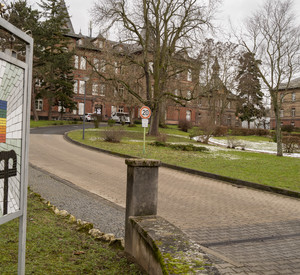 Blick auf ein Schild mit dem Schriftzug "ZOAR" und ein Gebäude.